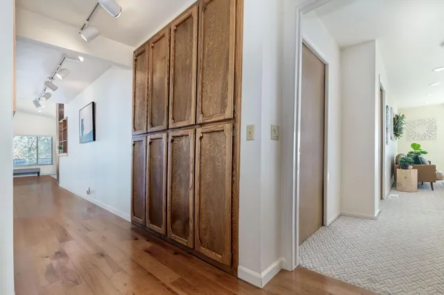 a view of an empty room with a chandelier fan