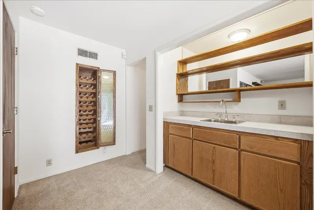 a front view of a house with a yard and trees