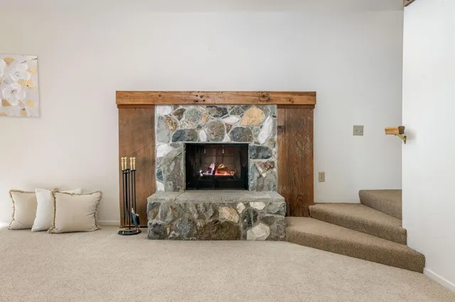 a view of a house with a yard and large tree