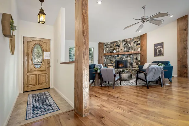 a view of a dining room with furniture water view and a floor to ceiling window