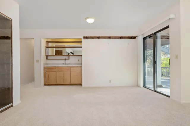 a view of a balcony with wooden floor and fence