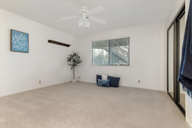 a balcony with wooden floor and yard in the back