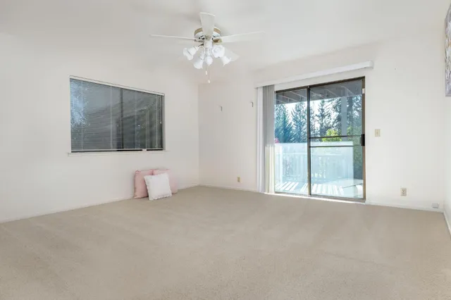 a view of backyard with wooden floor and fence