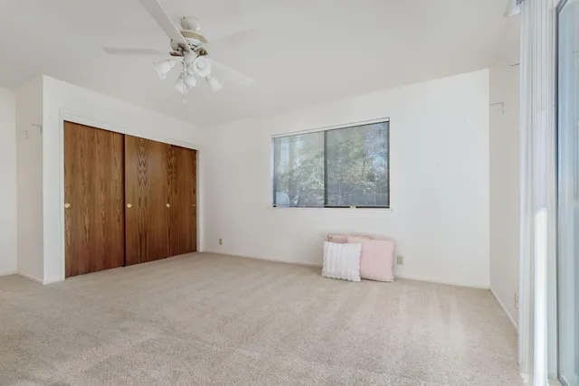 a view of a patio with table and chairs near a yard