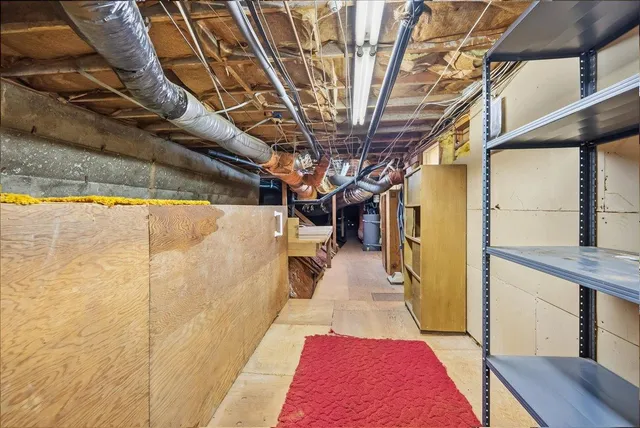 an aerial view of residential house with outdoor space and trees all around