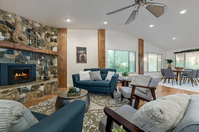 a kitchen with a table chairs refrigerator and cabinets