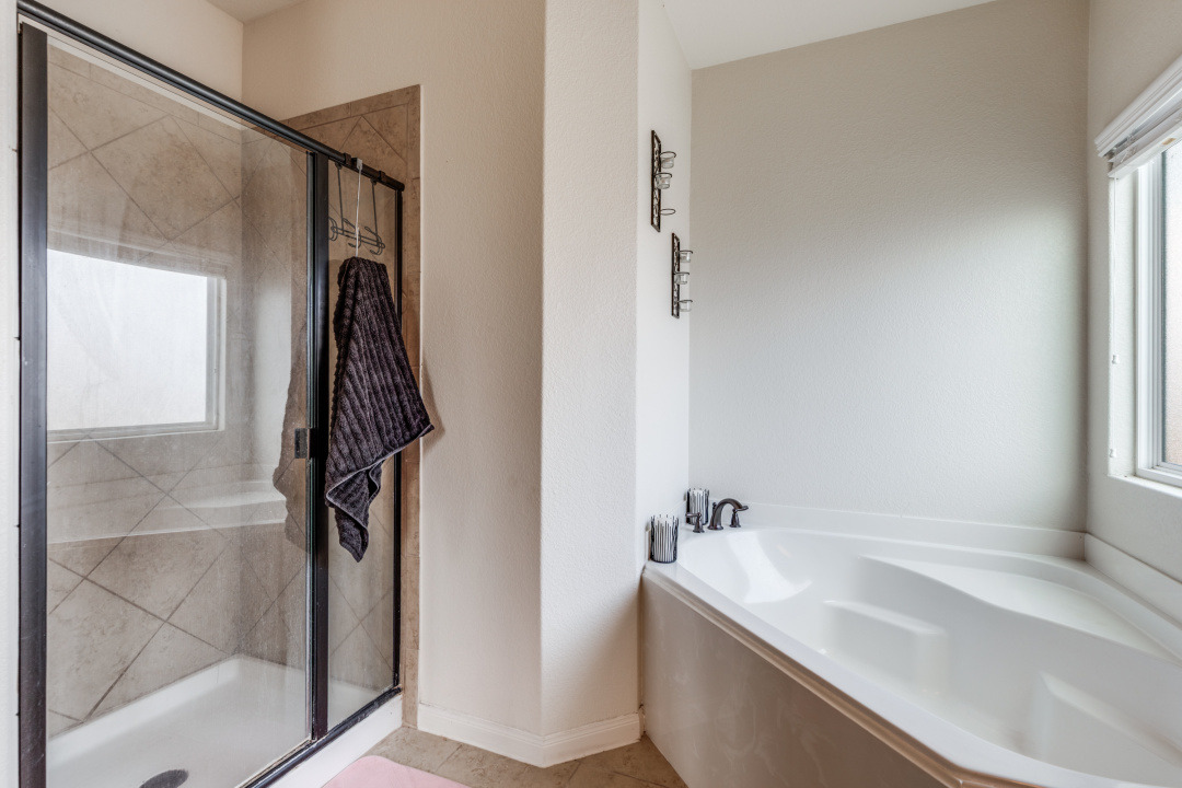 1524 Treeta Trail Kyle, TX 78640 - Photo 16 of 25 a bathroom with a tub and a shower