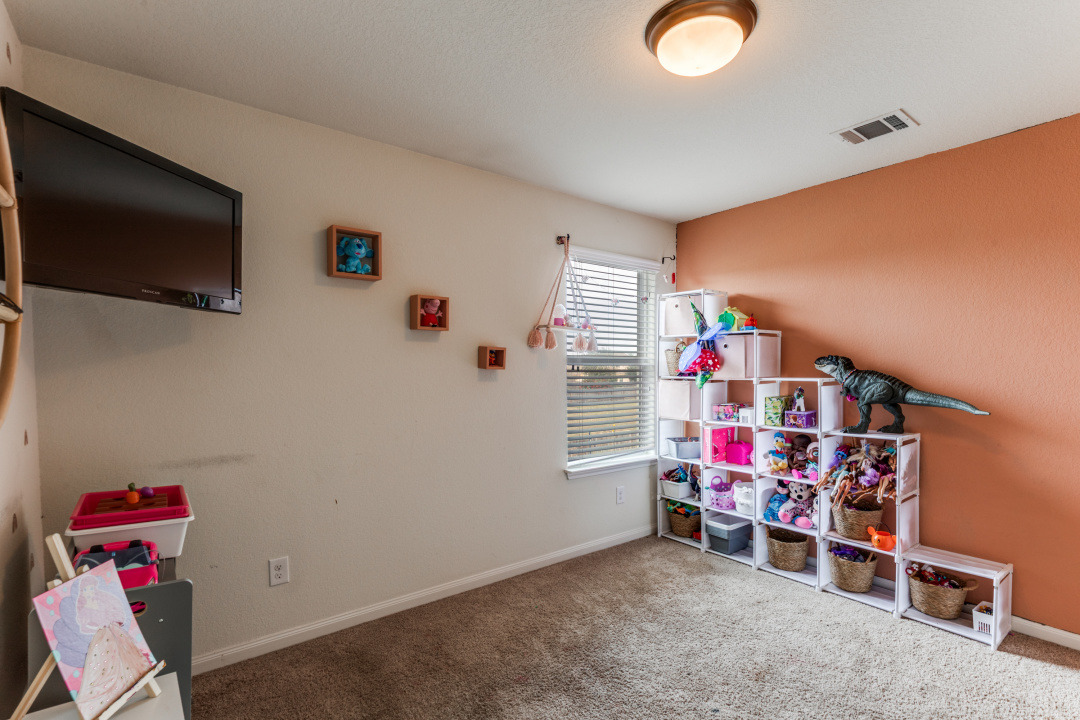 1524 Treeta Trail Kyle, TX 78640 - Photo 18 of 25 a children room with toys and a flat screen tv