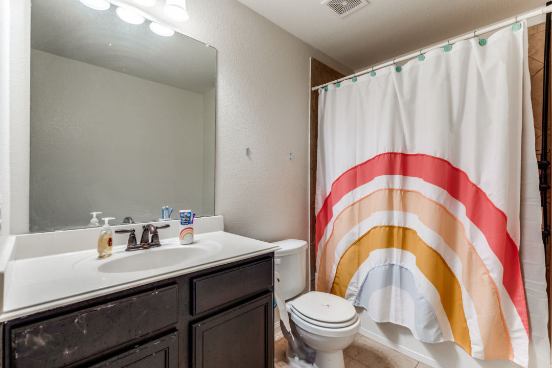 1524 Treeta Trail Kyle, TX 78640 - Photo 20 of 25 a bathroom with a sink and a mirror