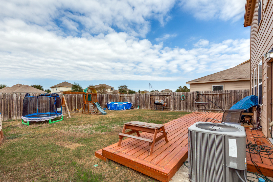 1524 Treeta Trail Kyle, TX 78640 - Photo 21 of 25 a view of a swimming pool with a lounge chairs