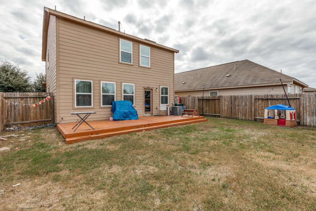 1524 Treeta Trail Kyle, TX 78640 - Photo 25 of 25 a view of a house with a backyard and a yard