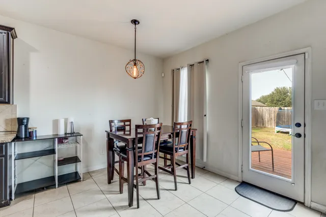 a view of a dining room with furniture and chandelier