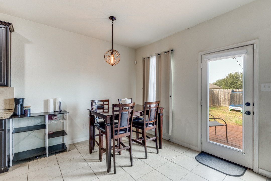 1524 Treeta Trail Kyle, TX 78640 - Photo 6 of 25 a view of a dining room with furniture and chandelier