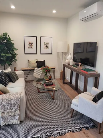 a living room with furniture ceiling fan and a window