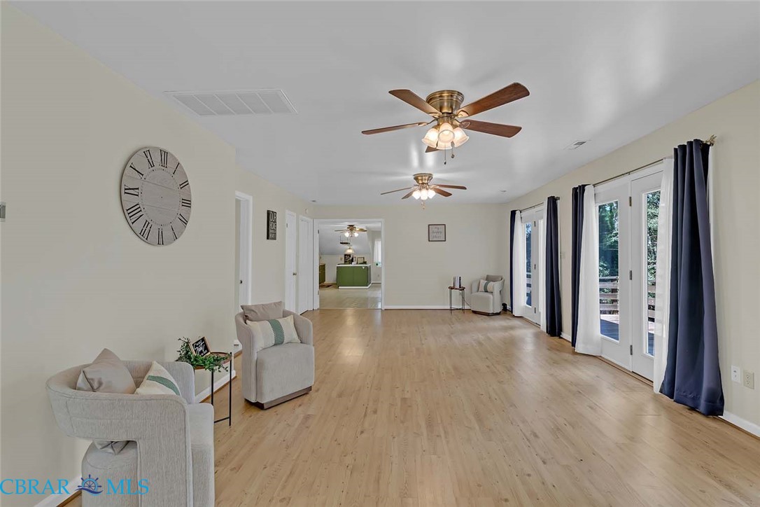 423 Kings Landing Road Onemo, VA 23130 - Photo 47 of 63 a view of a livingroom with a furniture a ceiling fan and wooden floor