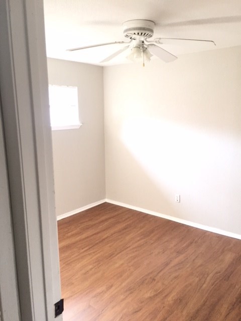 2606 Barbee Street, Unit 7 Houston, TX 77004 - Photo 5 of 8 a view of a small space with wooden floor and a window