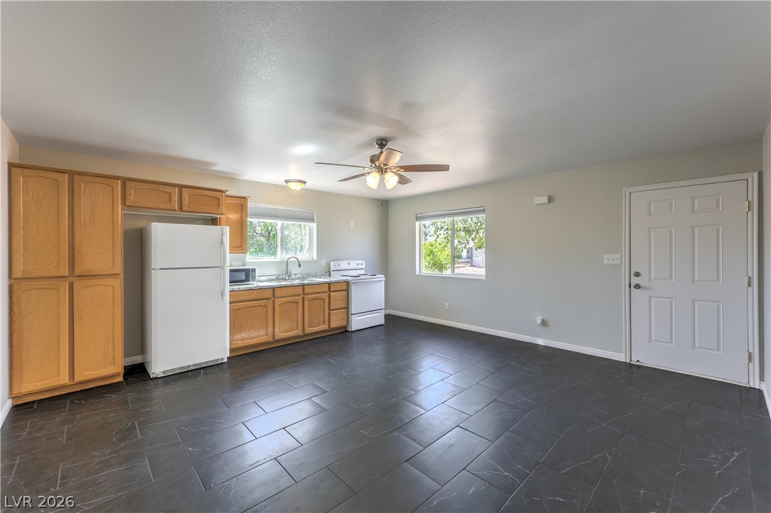 348 Tres Palomas Street Overton, NV 89040 - Photo 29 of 41 A well-equipped kitchen space features ample wood cabinetry and durable tiled flooring, creating an inviting atmosphere.