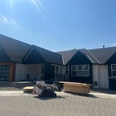 a front view of a house with a garden and parking space