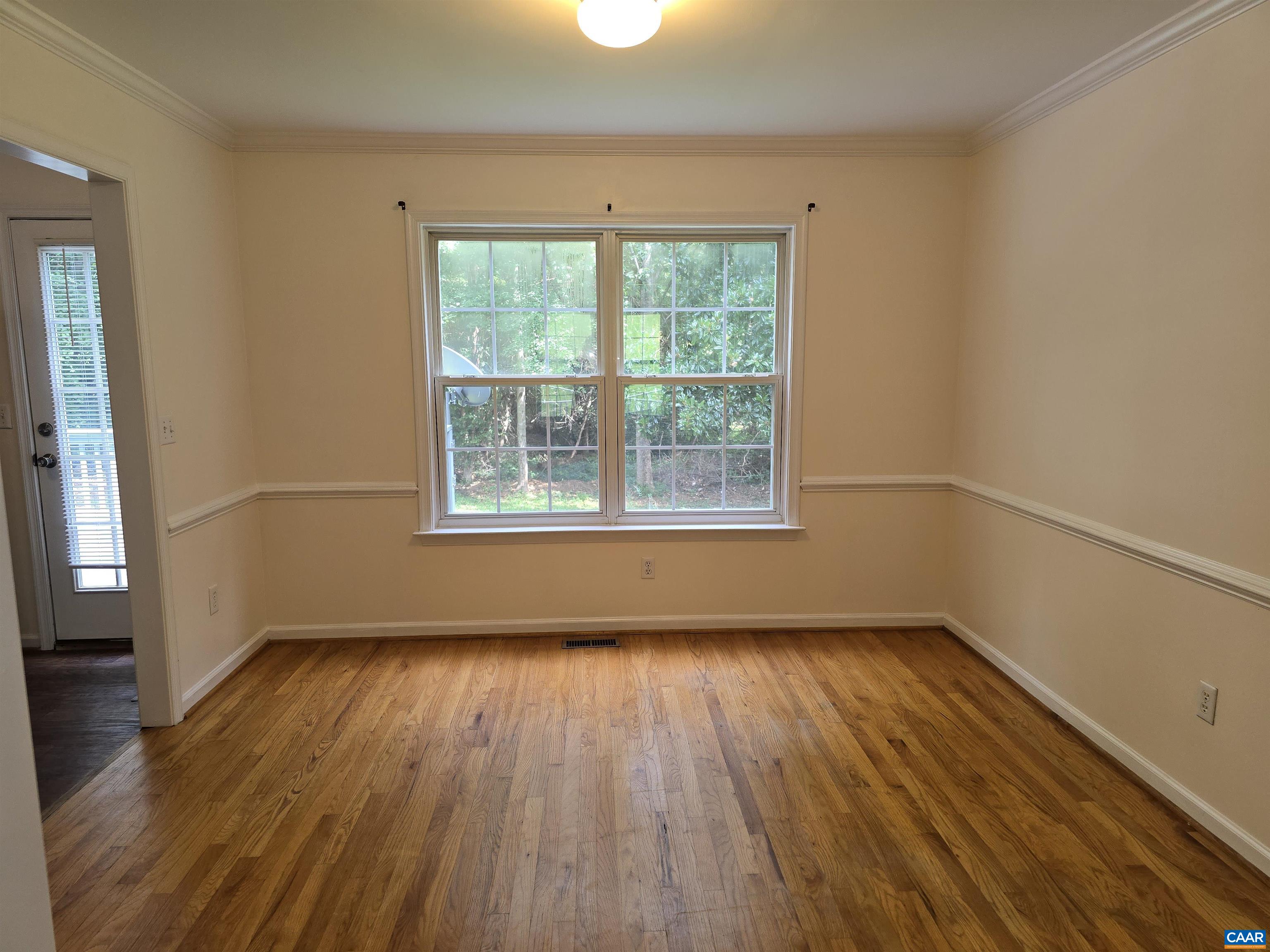 259 Spring Oaks Lane Ruckersville, VA 22968 - Photo 12 of 26 a view of an empty room with wooden floor and a window