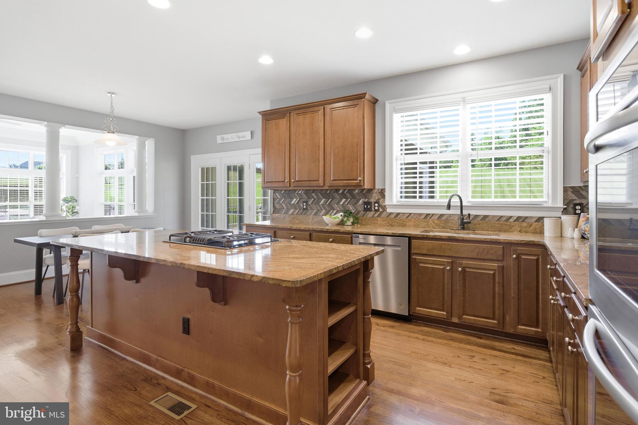 18475 Kerill Road Triangle, VA 22172 - Photo 52 of 99 a kitchen with stainless steel appliances granite countertop a stove a sink and a refrigerator