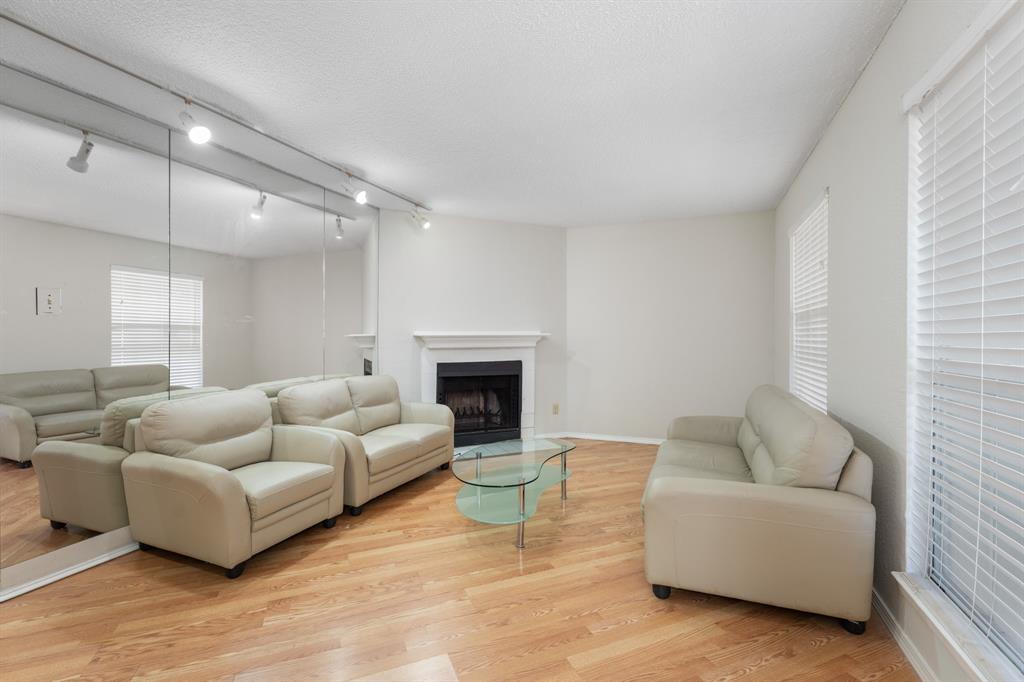 12480 Abrams Road, Unit 2601 Dallas, TX 75243 - Photo 1 of 1 a living room with furniture and a fireplace