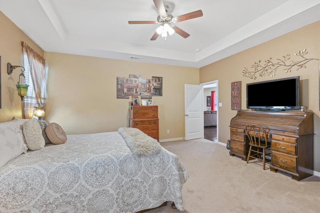 2375 County Road 4010 Decatur, TX 76234 - Photo 14 of 34 Bedroom featuring carpet, a raised ceiling, and ceiling fan