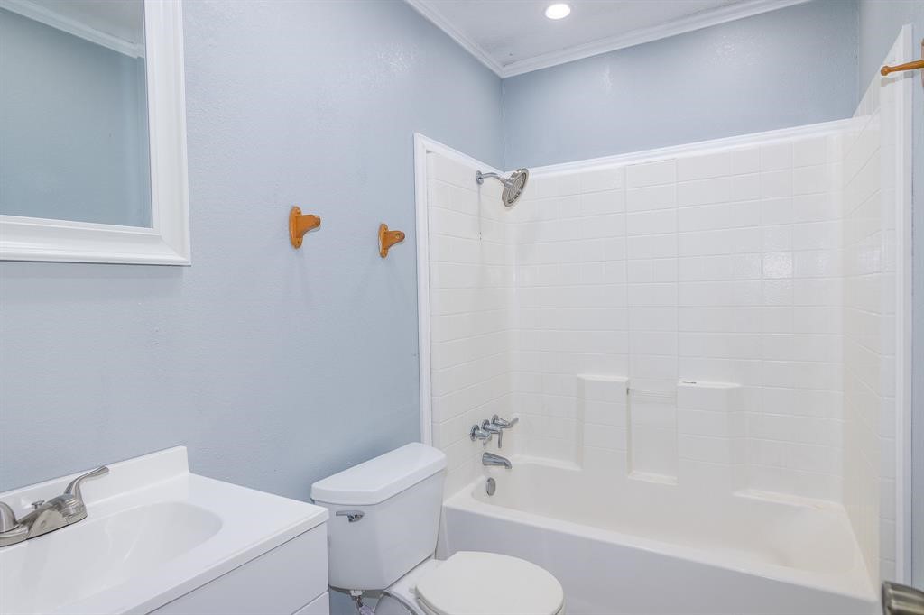 285 Debbies Boulevard Livingston, TX 77351 - Photo 7 of 10 a white toilet sitting next to a bath tub