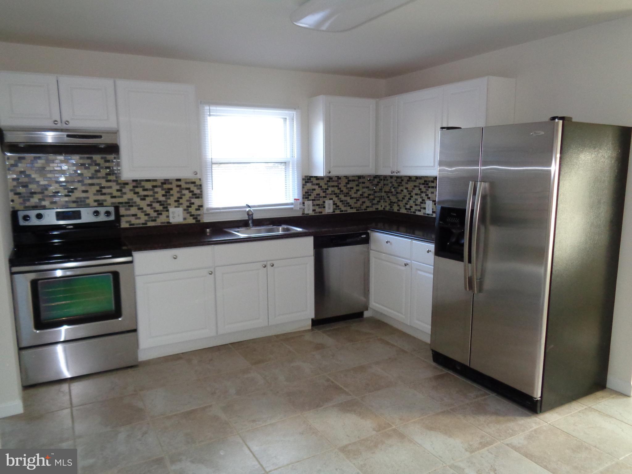 88 Leeland Road Fredericksburg, VA 22405 - Photo 12 of 22 a kitchen with a sink and a refrigerator