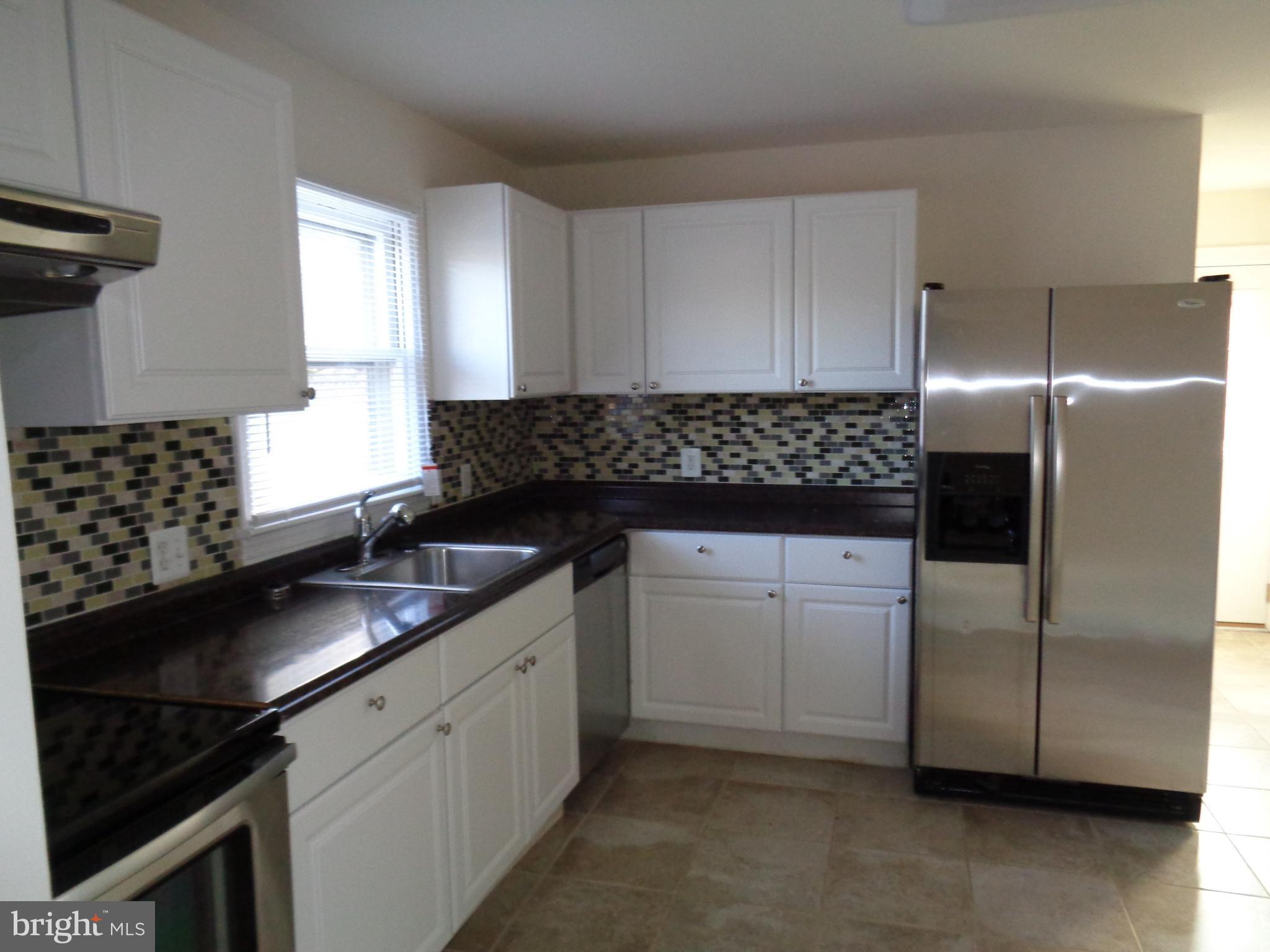 88 Leeland Road Fredericksburg, VA 22405 - Photo 13 of 22 a kitchen with granite countertop a sink stove and refrigerator