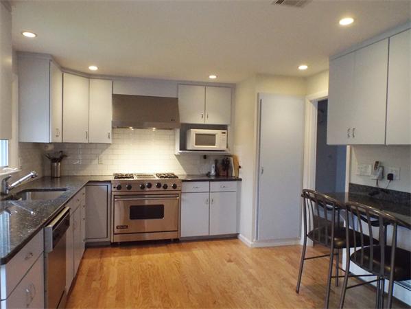 239 Worthen Road East Lexington, MA 02421 - Photo 6 of 13 a kitchen with stainless steel appliances granite countertop a stove a sink and a refrigerator