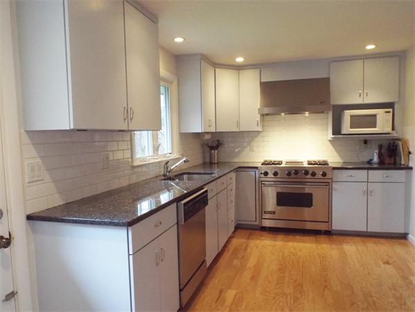 239 Worthen Road East Lexington, MA 02421 - Photo 7 of 13 a kitchen with stainless steel appliances granite countertop a stove a sink and a microwave