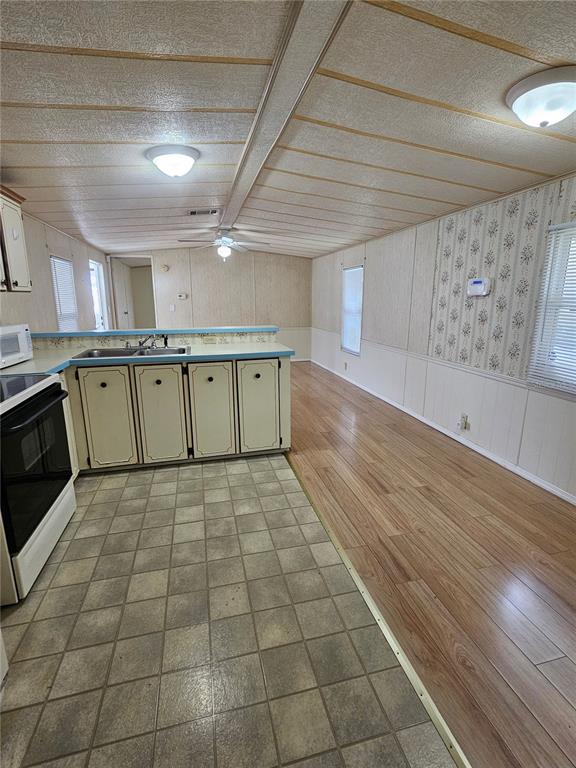 481 Chickadee Court Plant City, FL 33565 - Photo 5 of 17 a large room with a lot of cabinets and wooden floor
