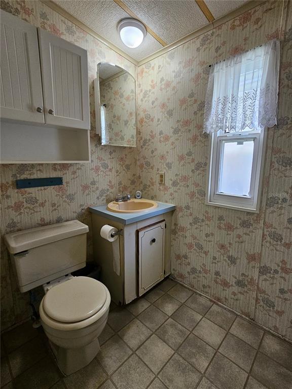 481 Chickadee Court Plant City, FL 33565 - Photo 10 of 17 a bathroom with a granite countertop toilet a sink and a shower