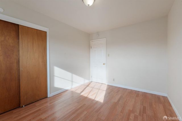 a view of an empty room and wooden floor