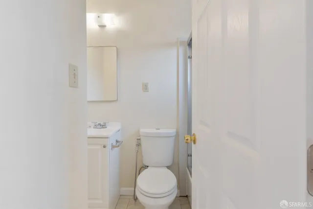 a white toilet sitting next to a shower