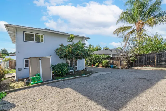 a front view of a house with a yard and a garage