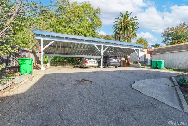 a view of backyard with a garden and palm trees