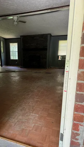 a view of empty room with window and fireplace
