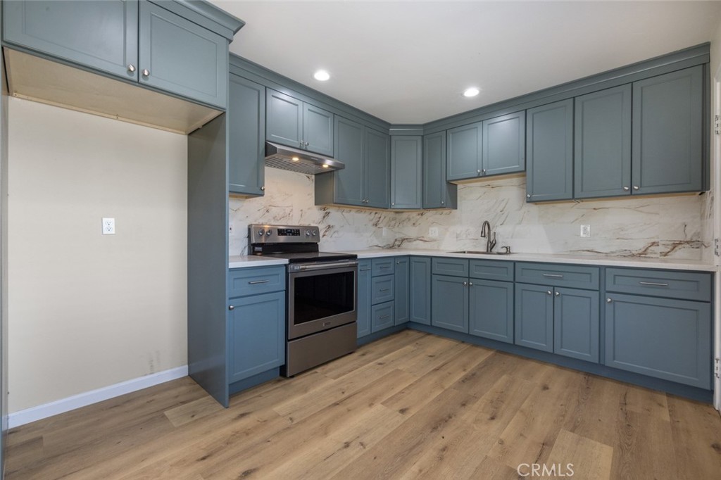 19247 3rd Stevinson, CA 95374 - Photo 12 of 50 a kitchen with stainless steel appliances granite countertop a stove a sink and a refrigerator