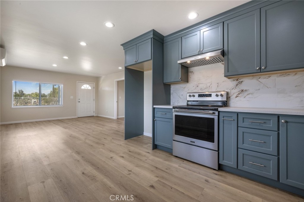 19247 3rd Stevinson, CA 95374 - Photo 14 of 50 a kitchen with granite countertop wooden floors and stainless steel appliances