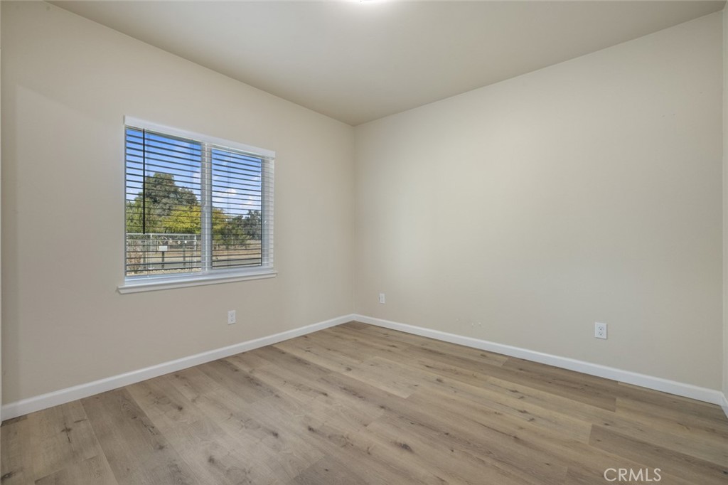19247 3rd Stevinson, CA 95374 - Photo 15 of 50 an empty room with wooden floor and windows