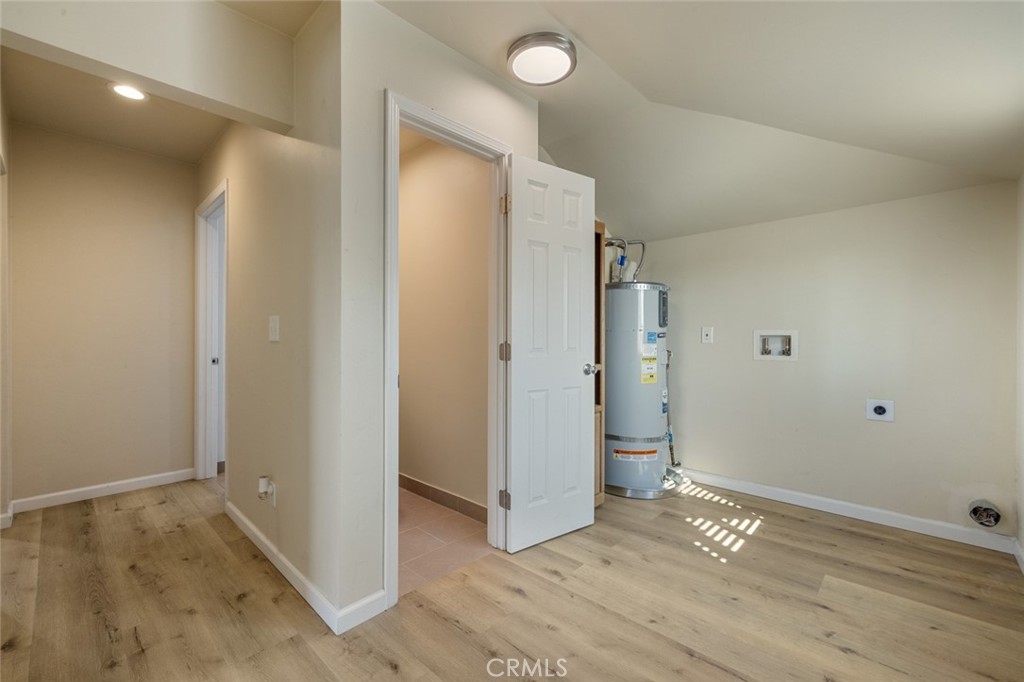 19247 3rd Stevinson, CA 95374 - Photo 28 of 50 an empty room with wooden floor and entrance to other room