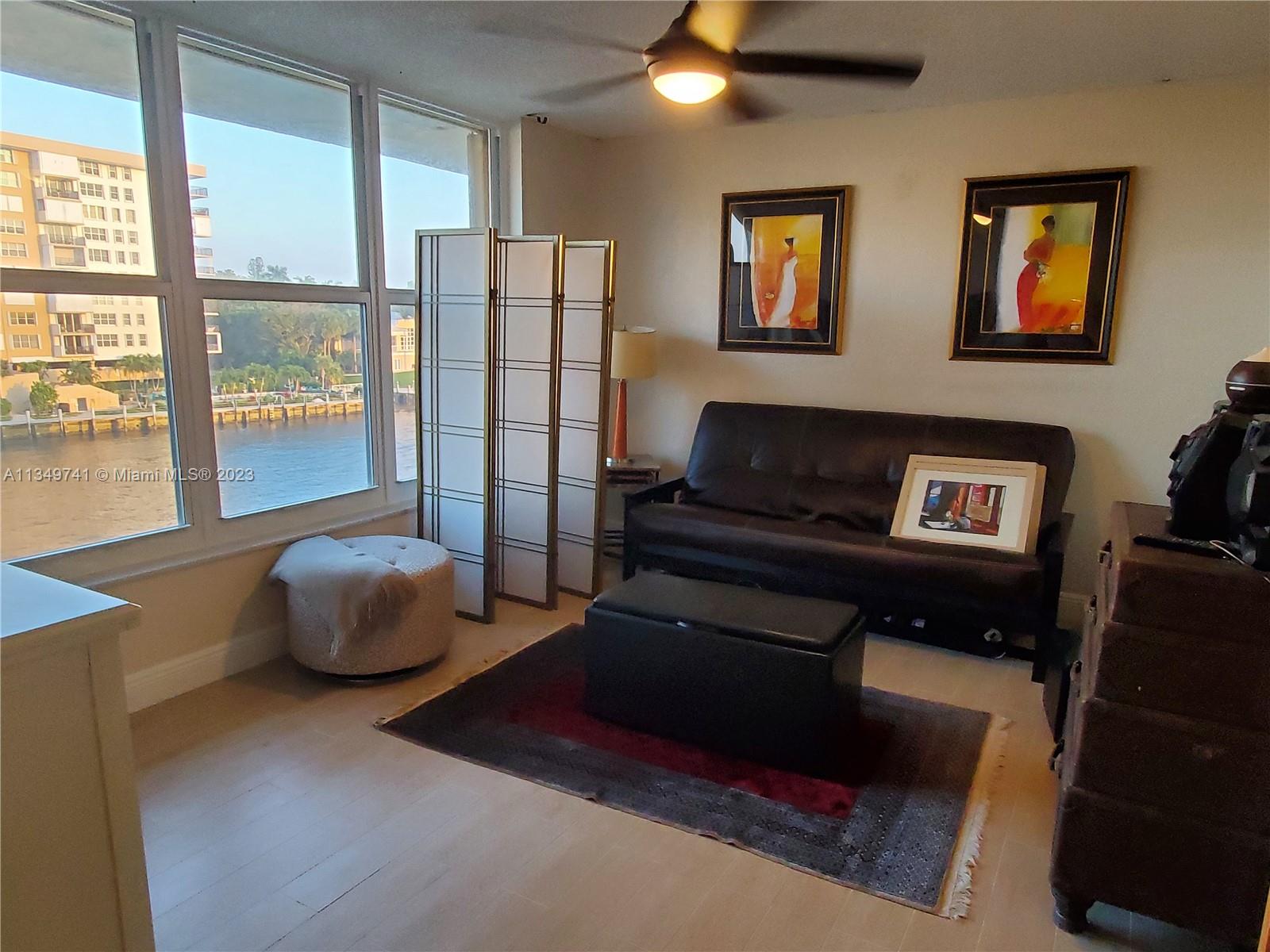 Lighthouse Point Lighthouse Point, FL 33064 - Photo 14 of 52 a living room with furniture and a gate