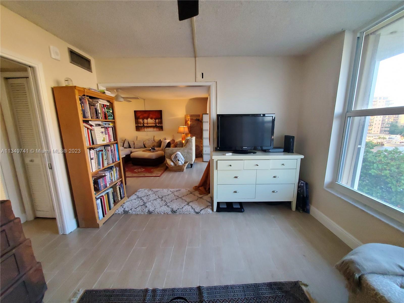 Lighthouse Point Lighthouse Point, FL 33064 - Photo 16 of 52 a bedroom with furniture and a window