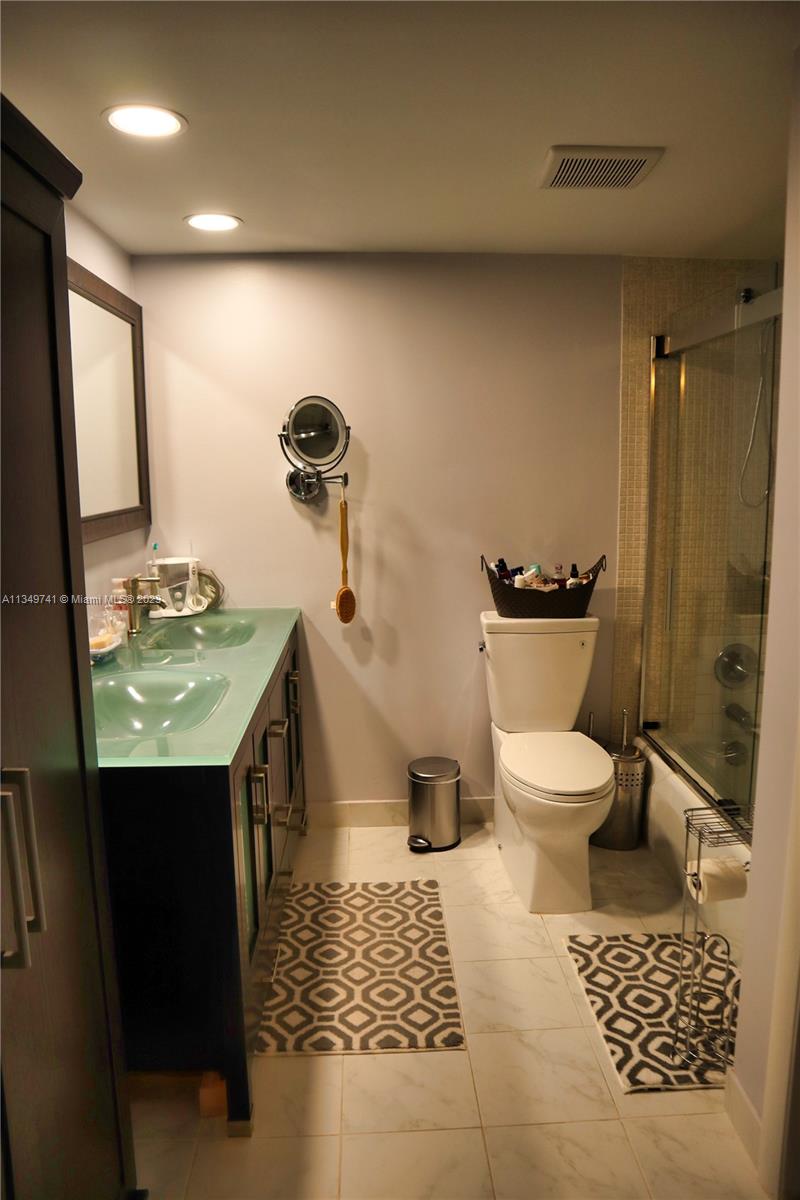 Lighthouse Point Lighthouse Point, FL 33064 - Photo 20 of 52 a bathroom with a toilet a sink and mirror