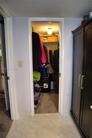 a living room with furniture and a walk in closet