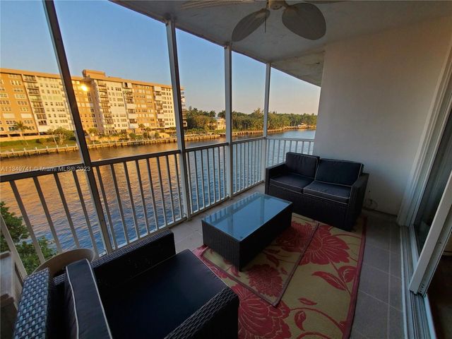 a view of a lake with a table and chairs