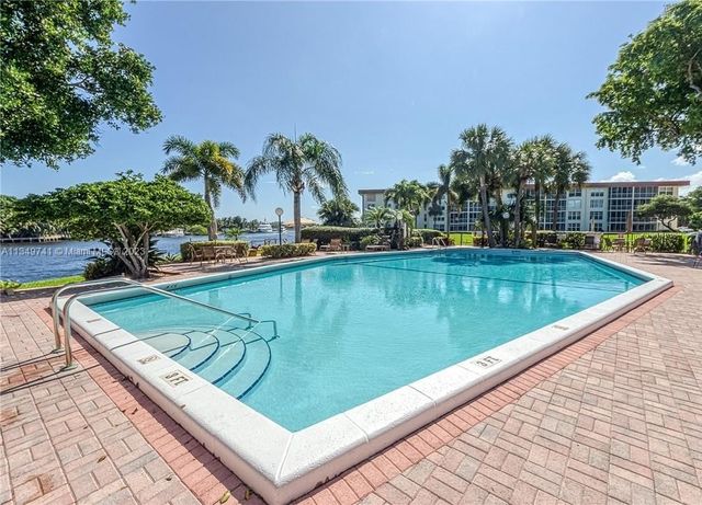 a balcony with beautiful flowers and trees