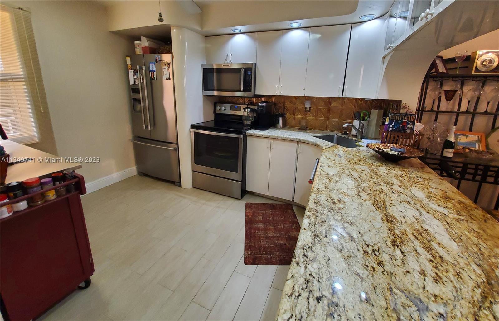 Lighthouse Point Lighthouse Point, FL 33064 - Photo 7 of 52 a kitchen with sink refrigerator and stove