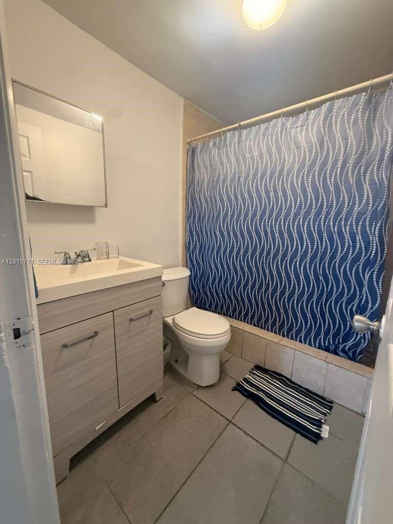 718 Southwest 11th Avenue, Unit 5 Miami, FL 33130 - Photo 6 of 6 a bathroom with a toilet a sink and a mirror